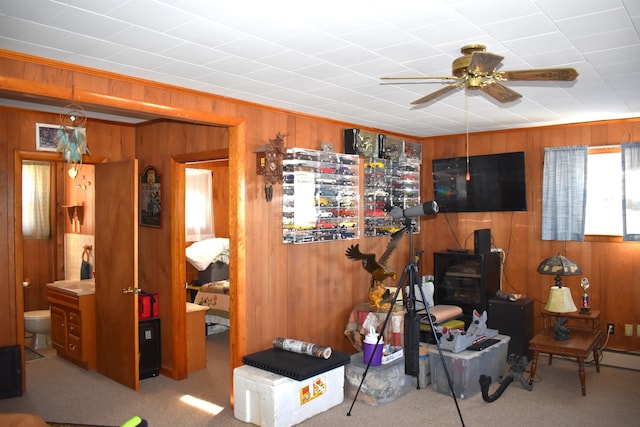 interior space featuring wooden walls and ceiling fan