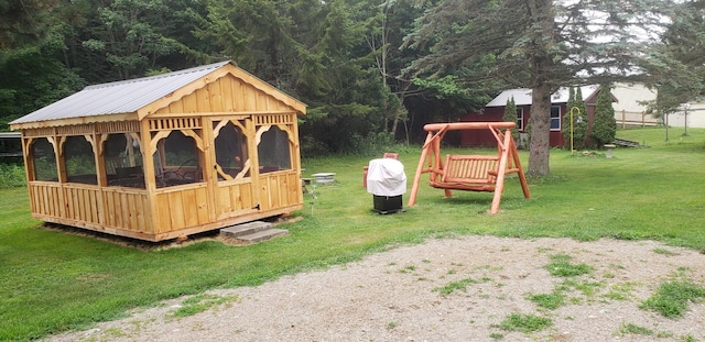 view of jungle gym with an outbuilding and a yard