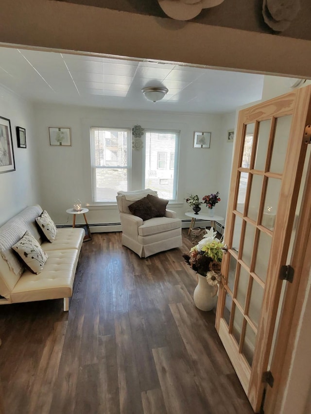 sitting room featuring a baseboard radiator and dark hardwood / wood-style flooring