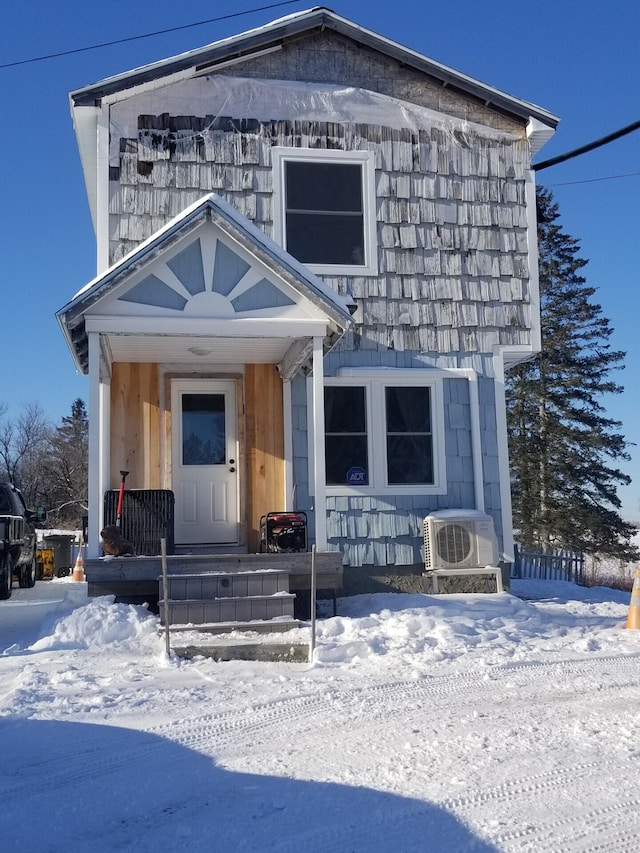 view of front of property featuring ac unit