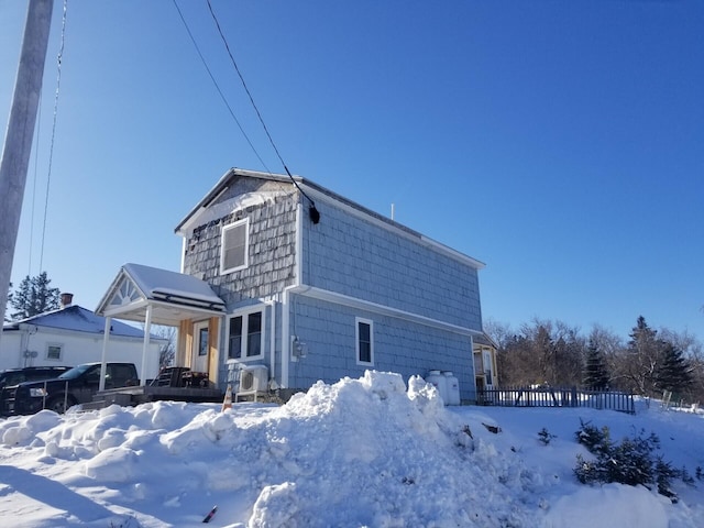 view of snow covered rear of property