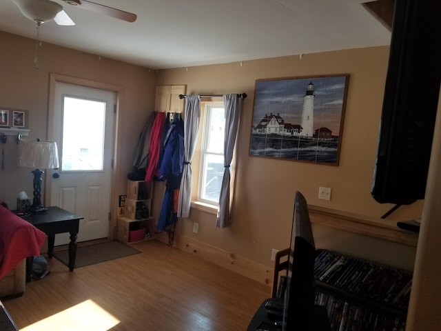 interior space with ceiling fan and wood-type flooring