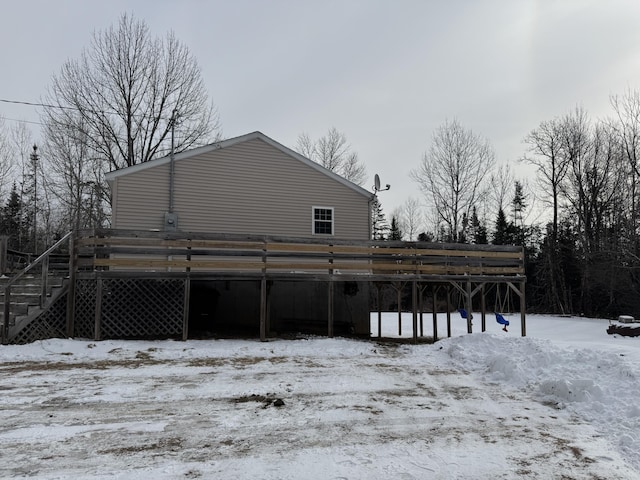 view of snow covered back of property