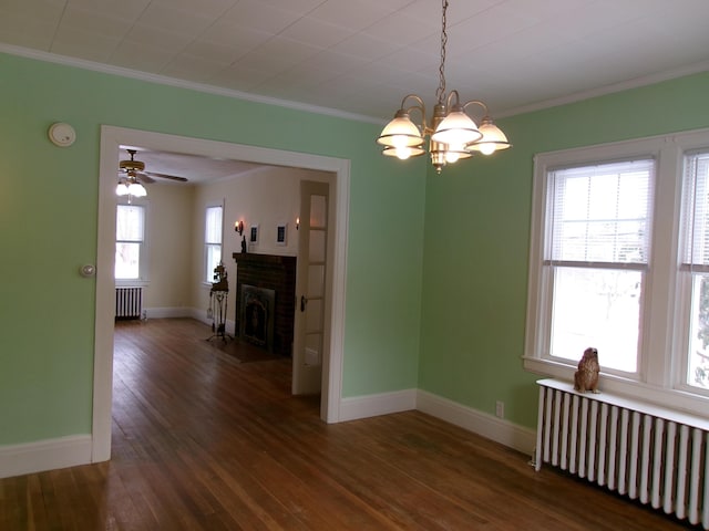 unfurnished dining area with crown molding, radiator heating unit, and plenty of natural light