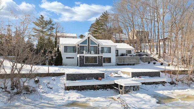 view of snow covered rear of property