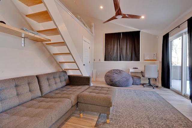 living room with lofted ceiling, light hardwood / wood-style floors, and ceiling fan