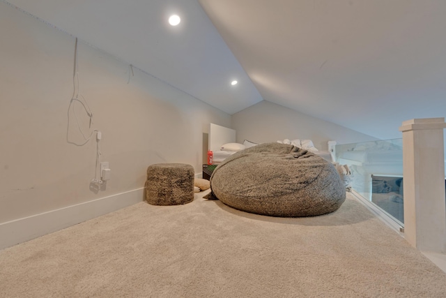 living area featuring carpet flooring and vaulted ceiling