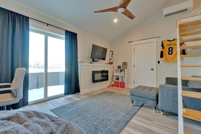 living room with hardwood / wood-style flooring, vaulted ceiling, a wall mounted air conditioner, and ceiling fan