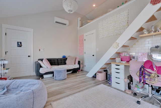 living room with lofted ceiling, light hardwood / wood-style flooring, and an AC wall unit
