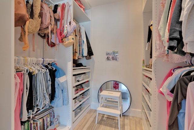 spacious closet with light hardwood / wood-style floors