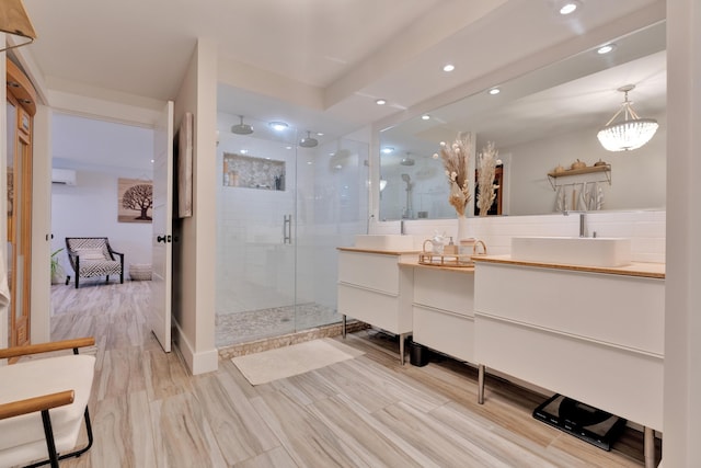 bathroom with vanity, a wall mounted air conditioner, and a shower with door