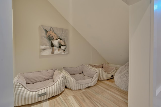 sitting room featuring hardwood / wood-style floors and vaulted ceiling