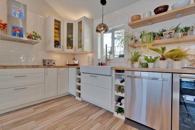 kitchen featuring wine cooler, wall chimney exhaust hood, white cabinetry, tasteful backsplash, and pendant lighting