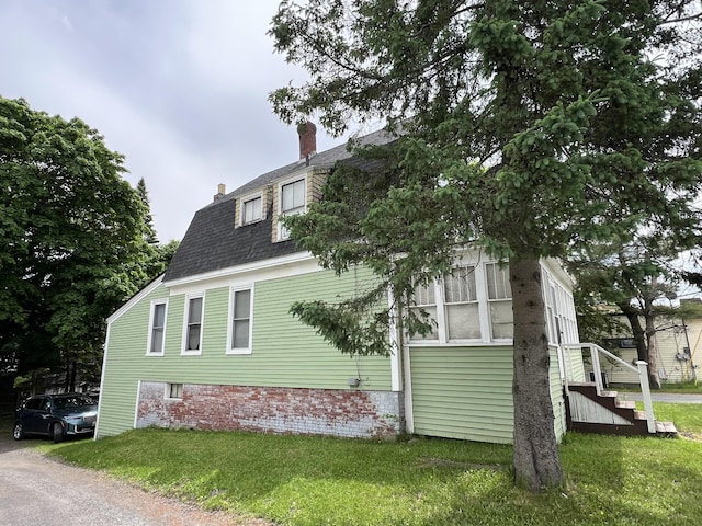 view of property exterior featuring a yard