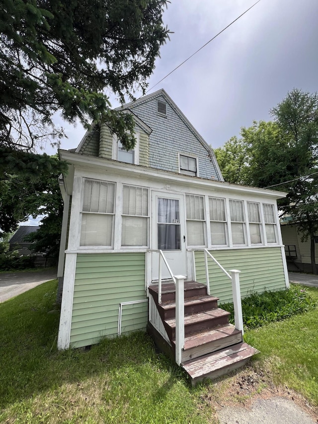 back of house with a lawn