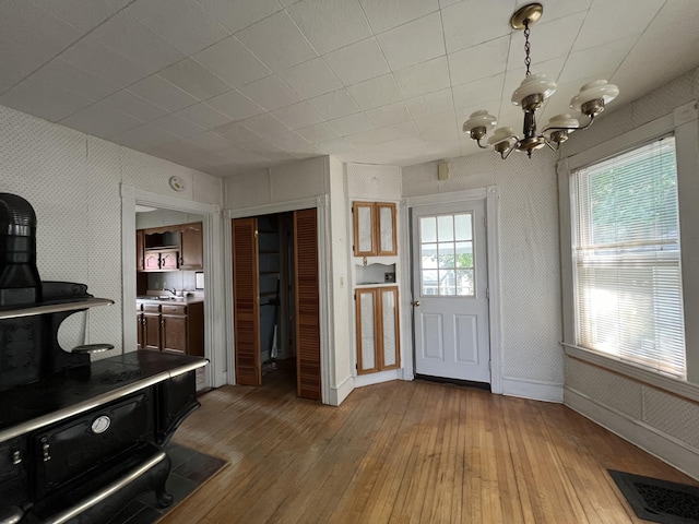 interior space with wood-type flooring, sink, and a chandelier