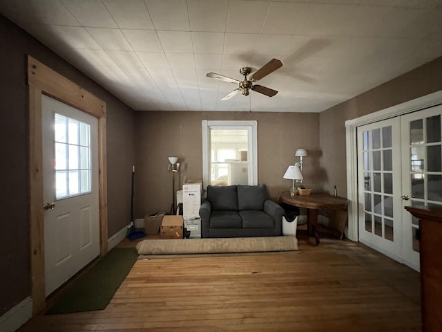 interior space with ceiling fan, french doors, and hardwood / wood-style floors