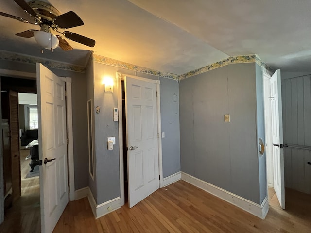 unfurnished bedroom with light wood-type flooring, ceiling fan, and vaulted ceiling