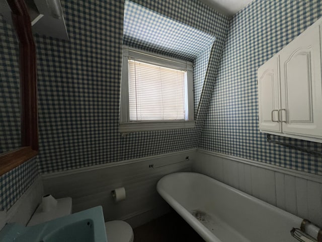 bathroom with a bath and toilet