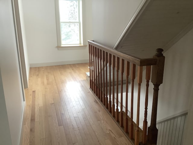 interior space with ornamental molding and light hardwood / wood-style flooring