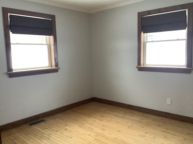 unfurnished room with light hardwood / wood-style flooring and ornamental molding