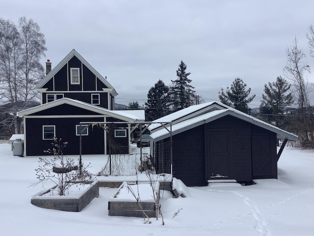 view of snow covered back of property