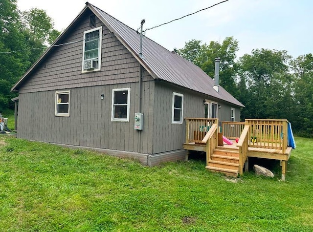 back of property featuring a yard and a deck