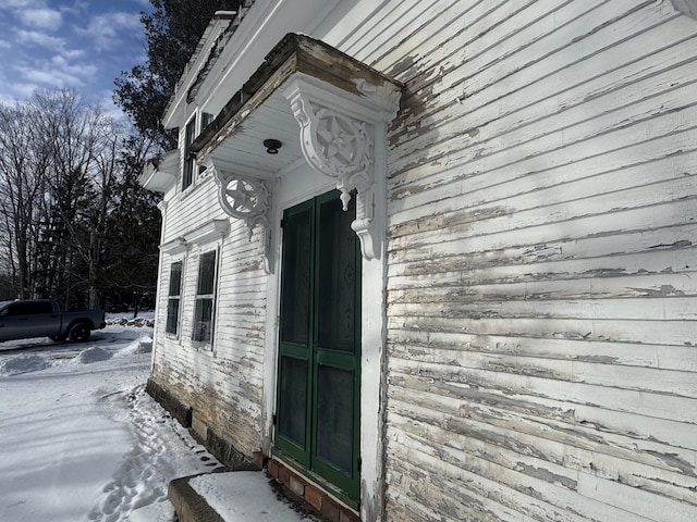 view of snow covered property entrance