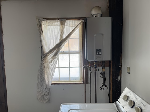 utilities featuring water heater and washer / dryer