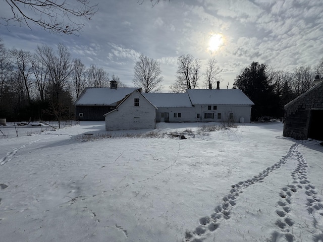 view of snow covered back of property