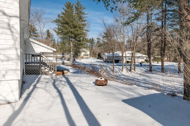 snow covered patio with an outdoor fire pit