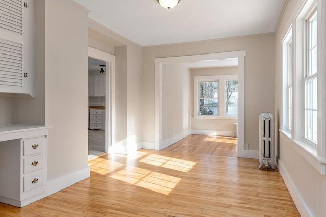 empty room with radiator and light hardwood / wood-style floors