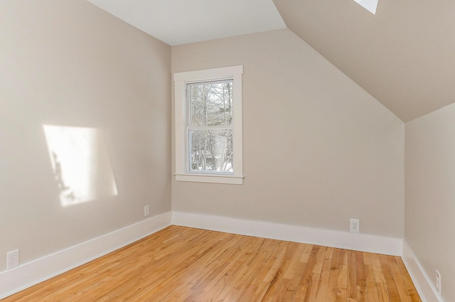 bonus room with vaulted ceiling and light hardwood / wood-style flooring