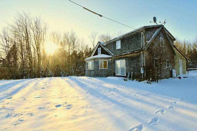 view of snow covered back of property