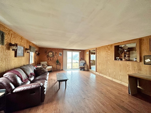 living room featuring hardwood / wood-style floors and wooden walls