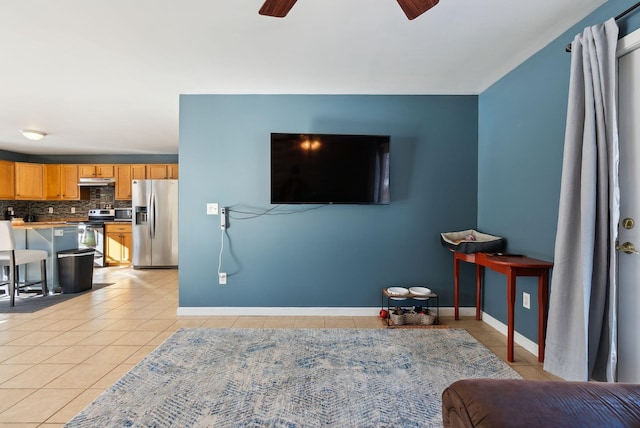 living room featuring light tile patterned flooring and ceiling fan