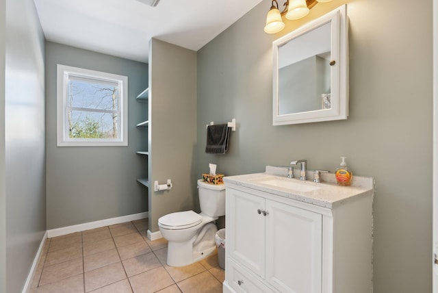 bathroom featuring vanity, tile patterned floors, and toilet