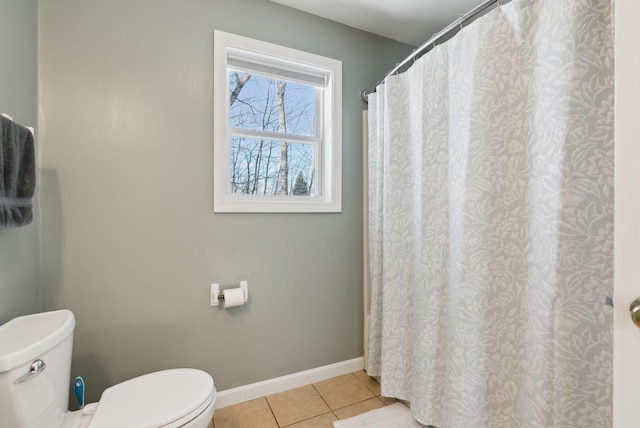 bathroom with toilet and tile patterned flooring