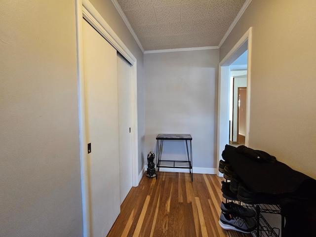 corridor featuring hardwood / wood-style floors and ornamental molding