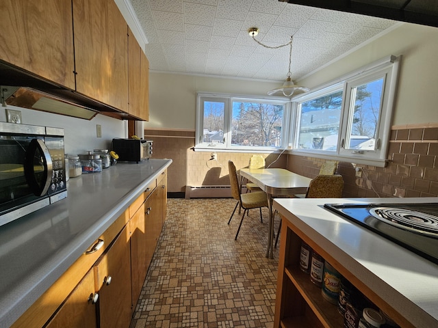 kitchen with stovetop and a baseboard heating unit