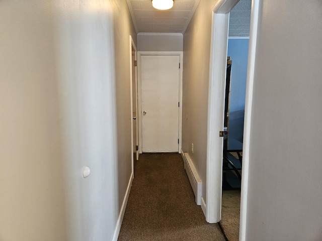 hallway with a baseboard radiator and dark colored carpet