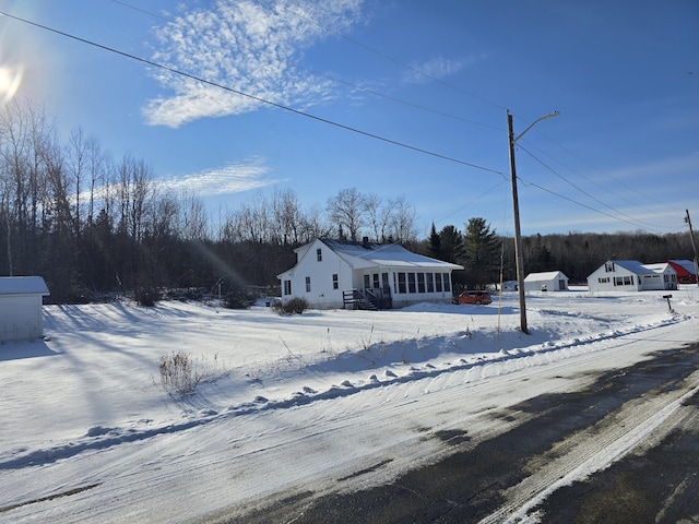 view of front of house with a sunroom