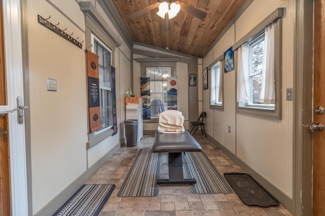 interior space with ceiling fan with notable chandelier and wood ceiling