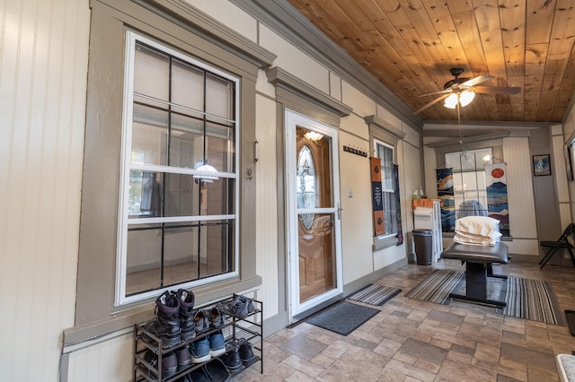 doorway to property with ceiling fan and a porch