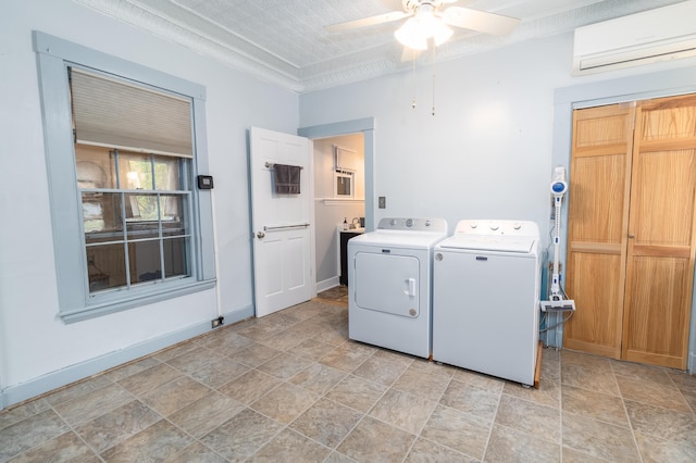 laundry room featuring ceiling fan, a wall unit AC, and independent washer and dryer