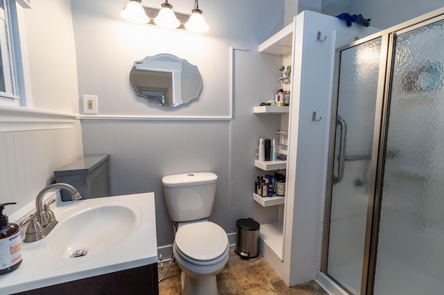 bathroom with vanity, toilet, and walk in shower