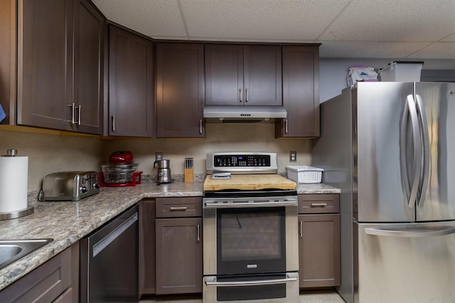 kitchen featuring a drop ceiling, stainless steel appliances, and dark brown cabinetry