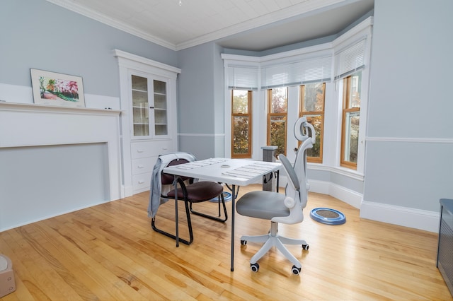 dining area with crown molding and light wood-type flooring