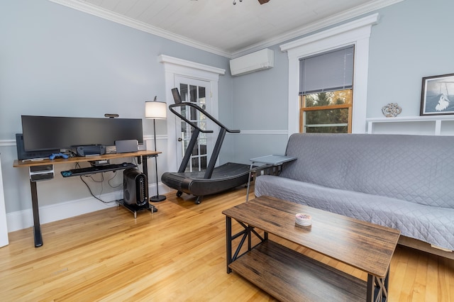 interior space featuring crown molding, ceiling fan, a wall mounted AC, and light wood-type flooring