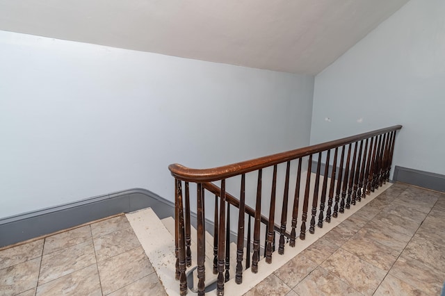 stairway with vaulted ceiling